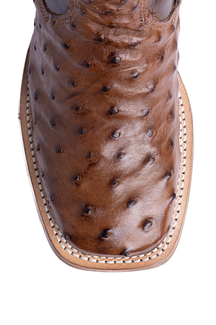 Detalhe do bico quadrado da bota masculina Strut em couro de avestruz cheio tabaco com solado costurado